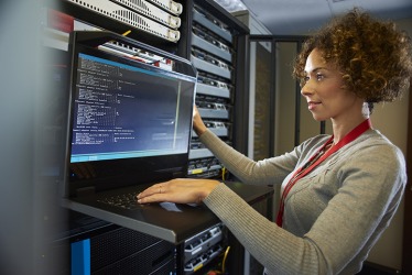 The employee is programming code on the computer. The employee is programming code on the computer.