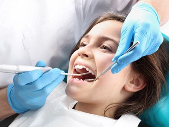 Grace is getting a prophylaxis by a dental hygienist. Grace is getting a prophylaxis by a dental hygienist.