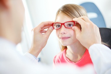 The young girl is getting glasses that are proportional to the size of her face. The young girl is getting glasses that are proportional to the size of her face.