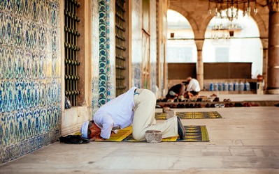 Man offering Namaz at mosque by taking on a prostrate position. Man offering Namaz at mosque by taking on a prostrate position.