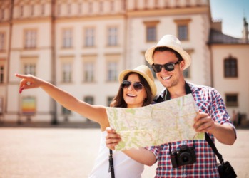 The couple stood in close proximity so that they could both read the map. The couple stood in close proximity so that they could both read the map.