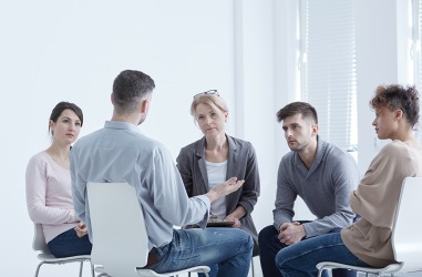 A group session of people sharing their experiences with PTSD. A group session of people sharing their experiences with PTSD.