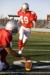 The football player punts the ball. The football player punts the ball.