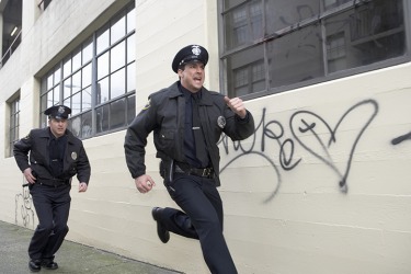 Two police officers pursuing a suspect. Two police officers pursuing a suspect.