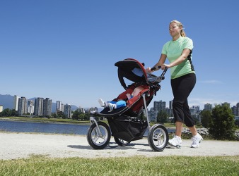 A mom pushes a stroller. A mom pushes a stroller.