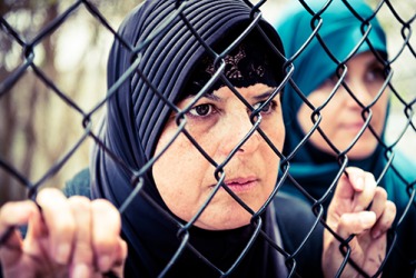 The woman is a refugee and hopes to find a safer place to live for herself and her family. The woman is a refugee and hopes to find a safer place to live for herself and her family.