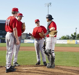The baseball players had a discussion on the mound to determine if the pitcher should be relieved. The baseball players had a discussion on the mound to determine if the pitcher should be relieved.