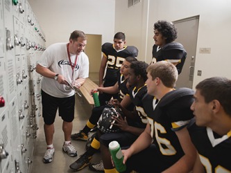 The rivalry between the high school football teams is intense, so the coach goes through the plays one more time before the start of the game. The rivalry between the high school football teams is intense, so the coach goes through the plays one more time before the start of the game.