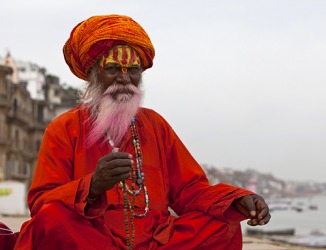 The Indian Sadhu has the characteristic face painting and wears the traditional colors of his people. The Indian Sadhu has the characteristic face painting and wears the traditional colors of his people.