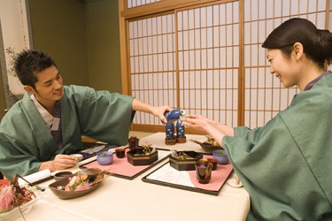 Japanese sake is poured into small ceramic cups and can be served warm or chilled depending on the season. Japanese sake is poured into small ceramic cups and can be served warm or chilled depending on the season.