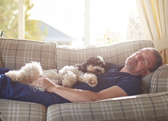 On days when Roy schlumps on the couch all afternoon, his dog Millie is happy to keep him company. On days when Roy schlumps on the couch all afternoon, his dog Millie is happy to keep him company.