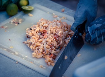 The scungilli (conch meat) is chopped into tiny pieces and added to the fritter batter. The scungilli (conch meat) is chopped into tiny pieces and added to the fritter batter.