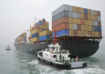 A tugboat helps a cargo ship maintain a safe amount of sea room when entering and leaving a harbor. A tugboat helps a cargo ship maintain a safe amount of sea room when entering and leaving a harbor.