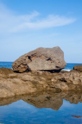 A boulder beside a tide pool. A boulder beside a tide pool.