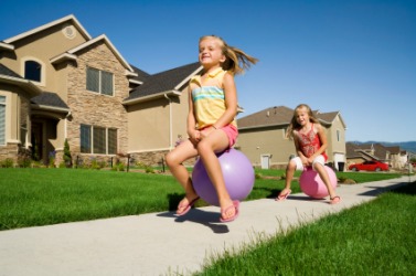 Two girls playing on bouncing balls. Two girls playing on bouncing balls.
