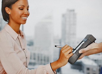 The delivery person asked Iris to put her signature on the handheld delivery device. The delivery person asked Iris to put her signature on the handheld delivery device.