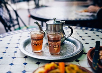 The Moroccan pomegranate tea is served on a silver-plate platter. The Moroccan pomegranate tea is served on a silver-plate platter.