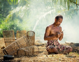 Weaving baskets from bamboo is a skill taught to the man by his own father. Weaving baskets from bamboo is a skill taught to the man by his own father.