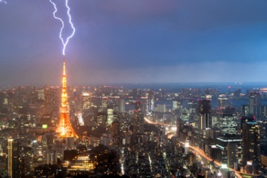 The lightening bolt smite the Tokyo tower during the thunderstorm. The lightening bolt smite the Tokyo tower during the thunderstorm.