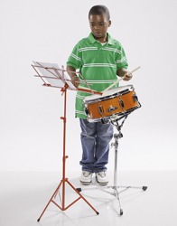 The young boy practices the snare drums. The young boy practices the snare drums.