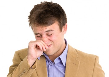 Andrew rubs his itchy nose and snorts due to sinus drainage from his seasonal allergies. Andrew rubs his itchy nose and snorts due to sinus drainage from his seasonal allergies.