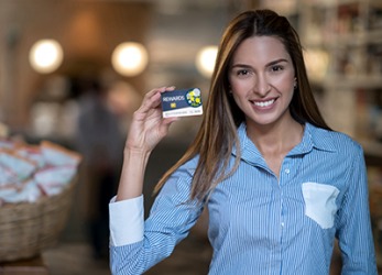Mia uses her customer loyalty card at her favorite grocery store to get rewards and discounts. Mia uses her customer loyalty card at her favorite grocery store to get rewards and discounts.
