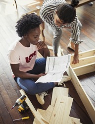 Sheryle and Melanie struggled with the vague instructions that came with the unassembled bookshelf. Sheryle and Melanie struggled with the vague instructions that came with the unassembled bookshelf.