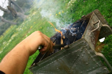 A brazier being used outdoors. A brazier being used outdoors.