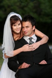 A bridegroom being embraced by his bride. A bridegroom being embraced by his bride.