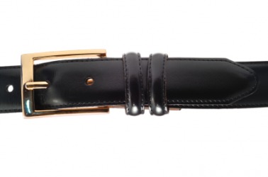 A black belt with a gold buckle. A black belt with a gold buckle.