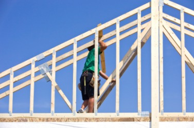 A man working to build a house. A man working to build a house.