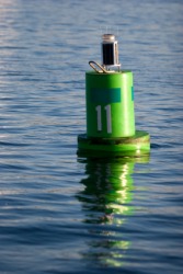 A channel marking buoy floating in a bay. A channel marking buoy floating in a bay.