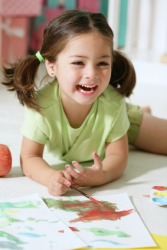 A happy child painting. A happy child painting.