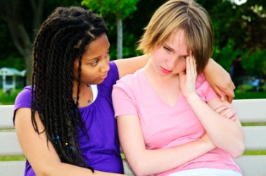 A girl showing compassion for her friend. A girl showing compassion for her friend.