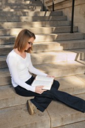 A coed studies on the college steps. A coed studies on the college steps.