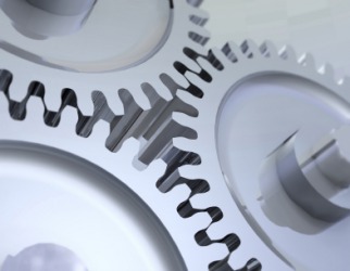 The cogs of three wheels fitted together. The cogs of three wheels fitted together.