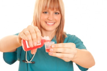 A nurse measuring out a dose of medicine. A nurse measuring out a dose of medicine.