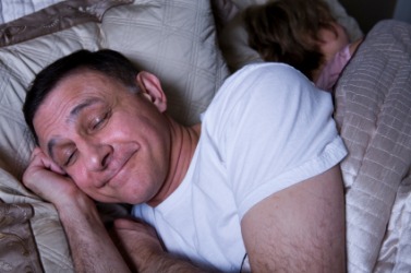 Maybe the smile means this sleeping man is having a nice dream. Maybe the smile means this sleeping man is having a nice dream.