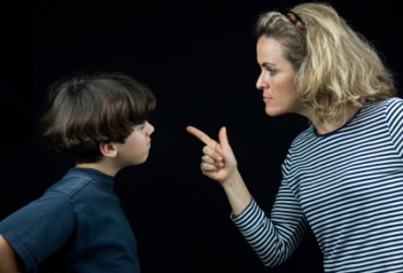 A boy recieves a thorough dressing-down from his mother. A boy recieves a thorough dressing-down from his mother.