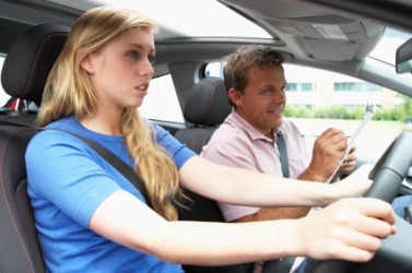 A young girl learning to drive a car. A young girl learning to drive a car.