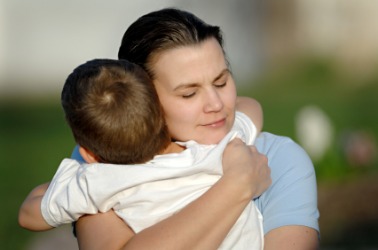 A mother embraces her son. A mother embraces her son.
