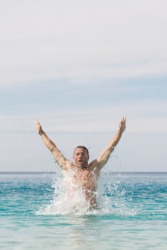 A swimmer emerges from the water. A swimmer emerges from the water.