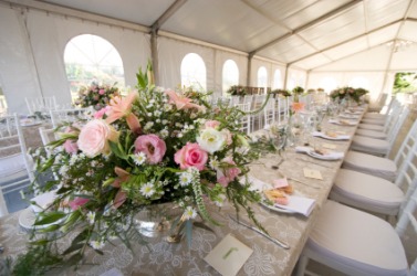 An embellishment of flowers on a table. An embellishment of flowers on a table.