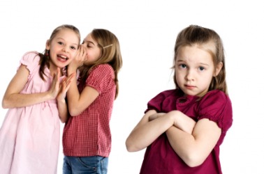 A little girl is being excluded by her friends. A little girl is being excluded by her friends.