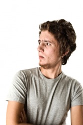 A young man looking askance. A young man looking askance.