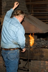 A blacksmith at his forge. A blacksmith at his forge.