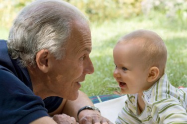 A child plays with his granddad. A child plays with his granddad.