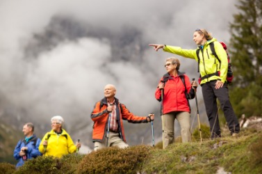 A young woman guides a group of hikers. A young woman guides a group of hikers.