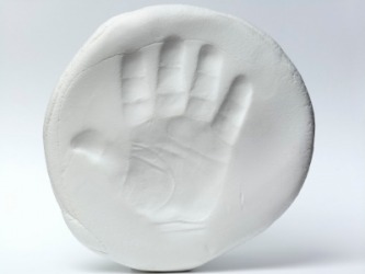 A baby's handprint in clay. A baby's handprint in clay.