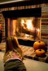 A little girl sits by the hearth. A little girl sits by the hearth.